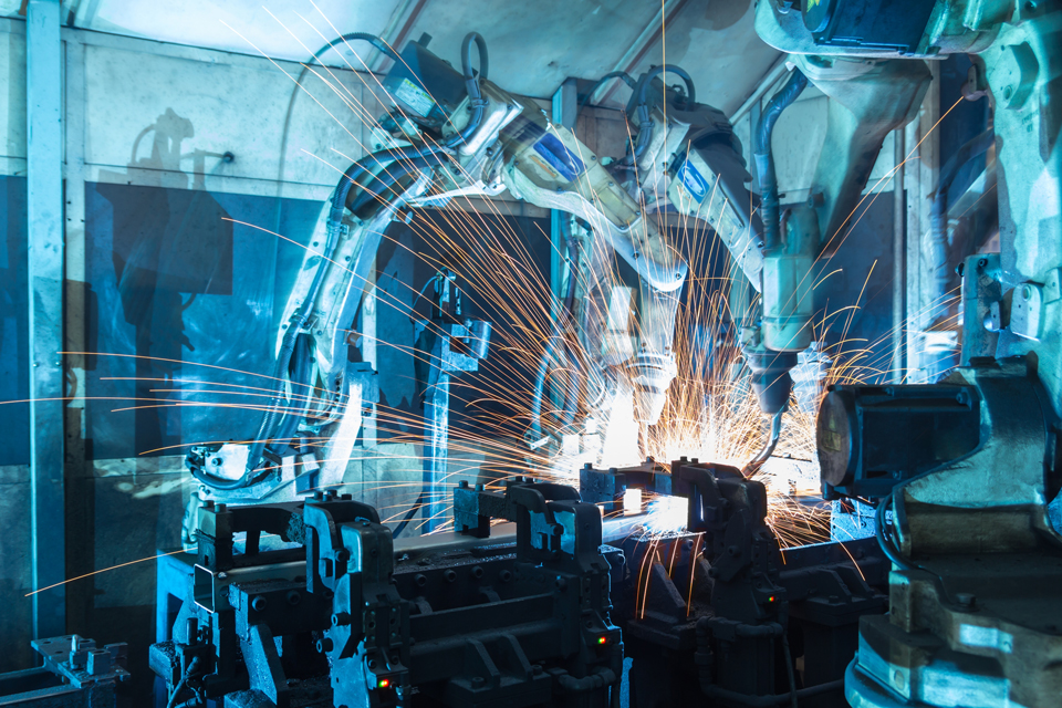 Robotic arms welding on a factory line